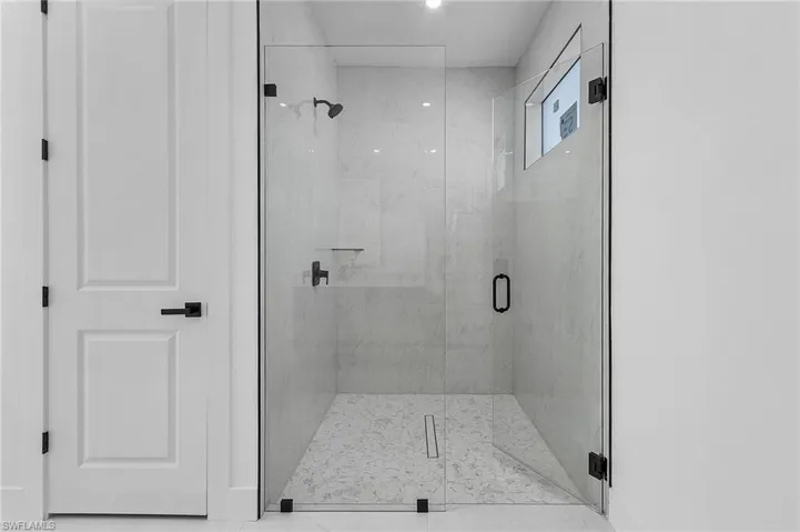 Bathroom with a shower with door