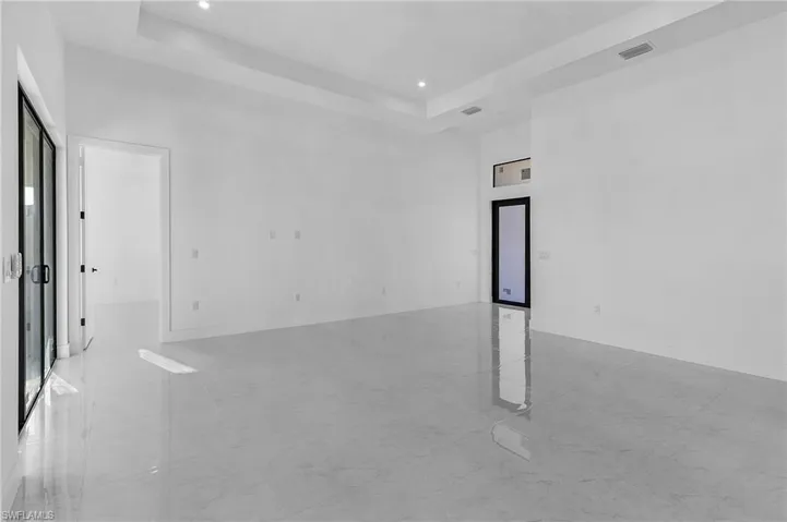 Unfurnished room with a raised ceiling