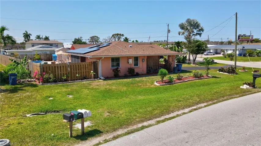 Ranch-style house with a front yard and solar panels