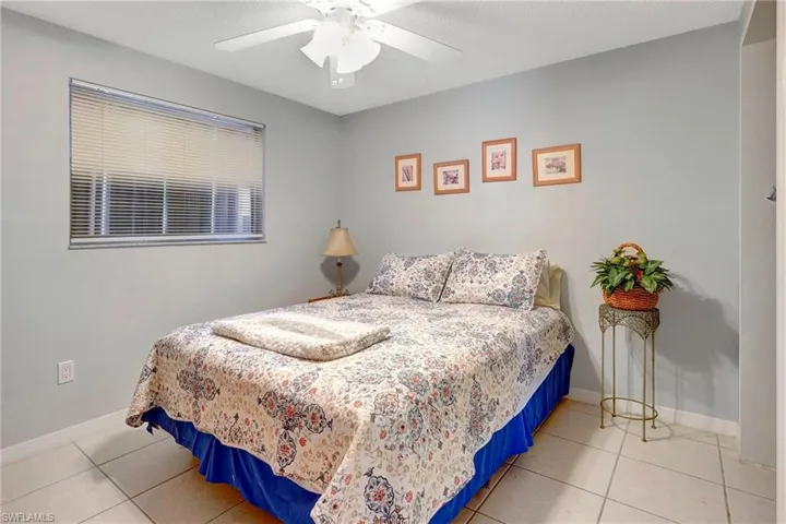 Bedroom featuring ceiling fan and light tile floors