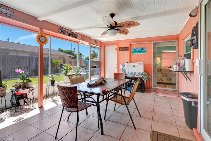 Sunroom with beamed ceiling and ceiling fan