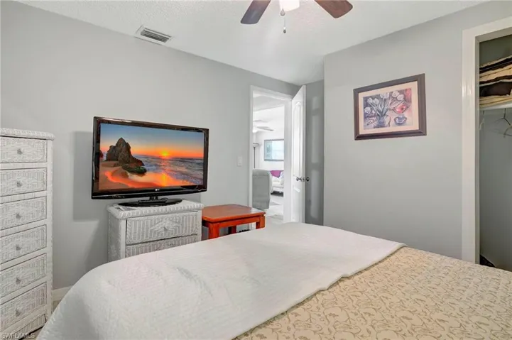 Bedroom featuring a textured ceiling, a closet, and ceiling fan