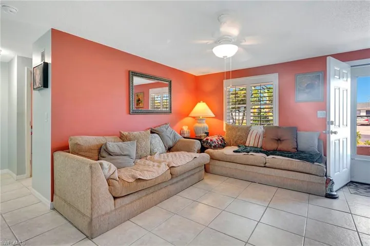 Tiled living room featuring ceiling fan