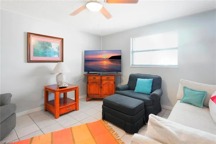 Tiled living room featuring ceiling fan
