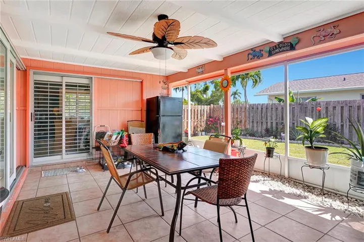 Sunroom / solarium with ceiling fan, beam ceiling, and a wealth of natural light