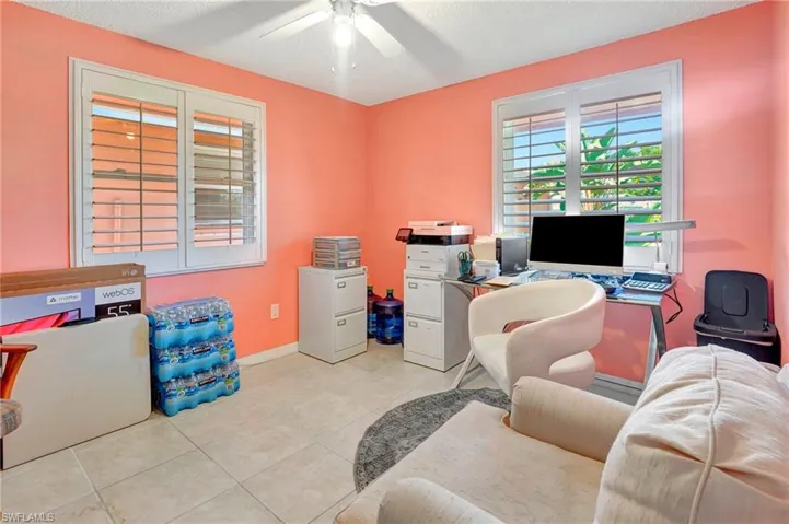 Tiled office featuring ceiling fan