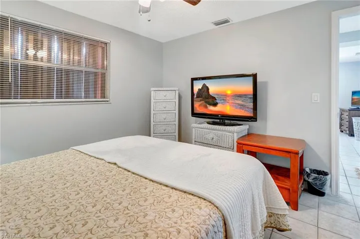 Bedroom featuring ceiling fan and tile floors