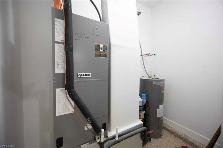 Utility area featuring an Allied brand air handler unit and a water heater