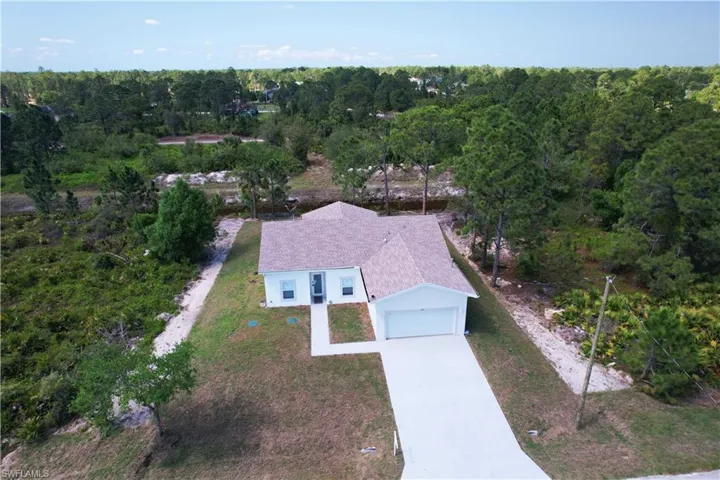 The property features a single-story residence with a light-colored exterior and a prominent garage
