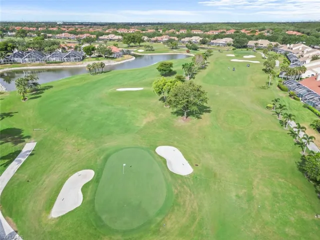 View of property location with nearby suburban area, a large body of water, and a local golf course