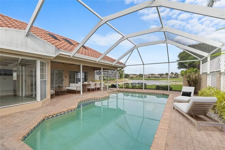 Swimming pool featuring a patio, an outdoor living space, and glass enclosure