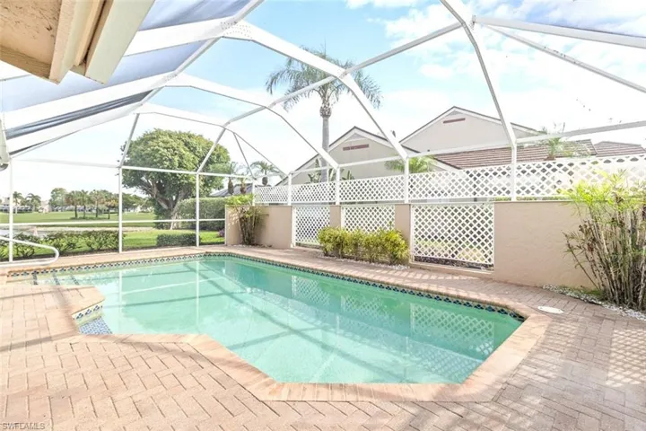 View of pool with a sunroom, glass enclosure, and a patio