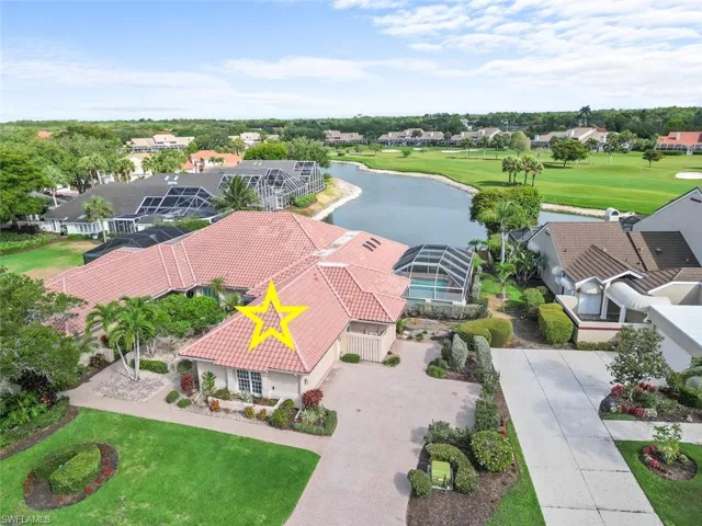 Aerial view of residential area with a large body of water and a golf club