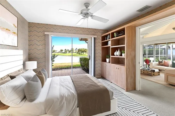 Bedroom with access to outside, light colored carpet, ceiling fan, and a water view