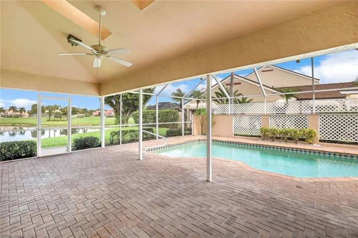 View of swimming pool featuring patio surround, a lanai, a sunroom, and a water view