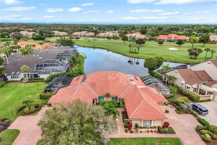 Aerial view of residential area with a large body of water and a golf course