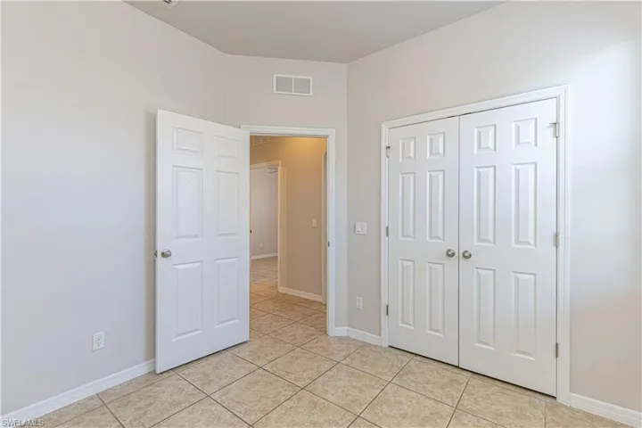 Unfurnished bedroom featuring a closet and light tile patterned floors