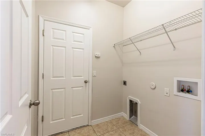 Laundry room with gas dryer hookup, light tile patterned flooring, washer hookup, and electric dryer hookup