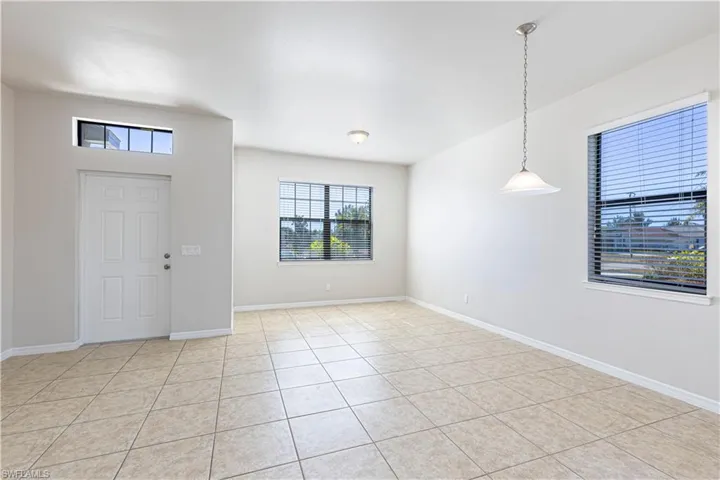 Entryway featuring baseboards and light tile patterned flooring