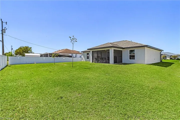 View of yard with a fenced backyard and a sunroom