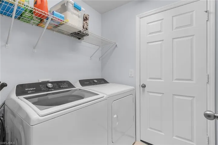 Washroom with laundry area and washing machine and dryer