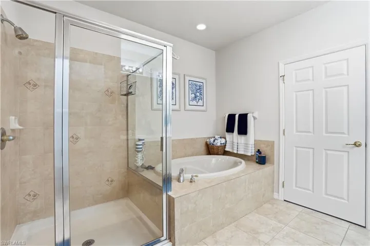 The primary ensuite features a soaking tub and large walk-in shower.