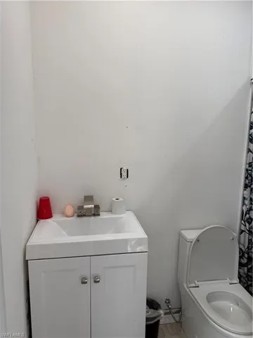 Full bathroom with vanity and a shower with shower curtain