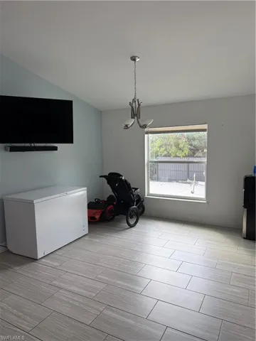 Unfurnished dining area with suspended lighting and wood finish floors