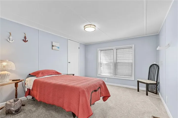 Bedroom with carpet flooring and baseboards