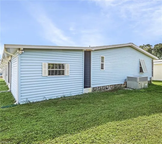 Rear view of house featuring a lawn