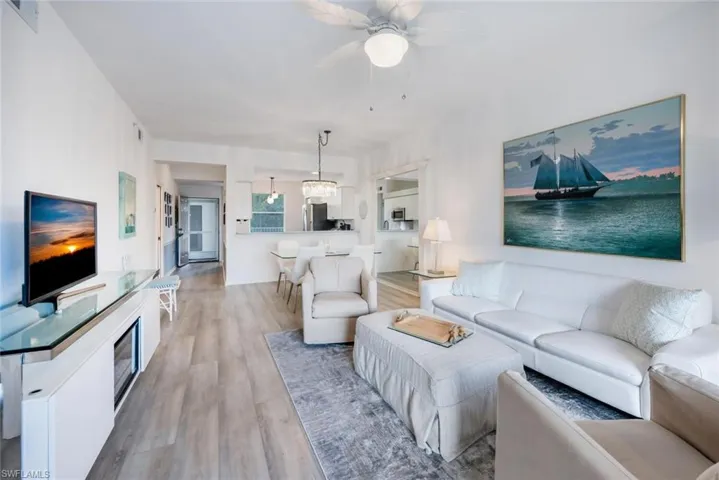 Living room featuring light wood-style floors and a ceiling fan