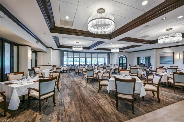 Dining space with crown molding, a chandelier, coffered ceiling, dark wood-style flooring, and recessed lighting