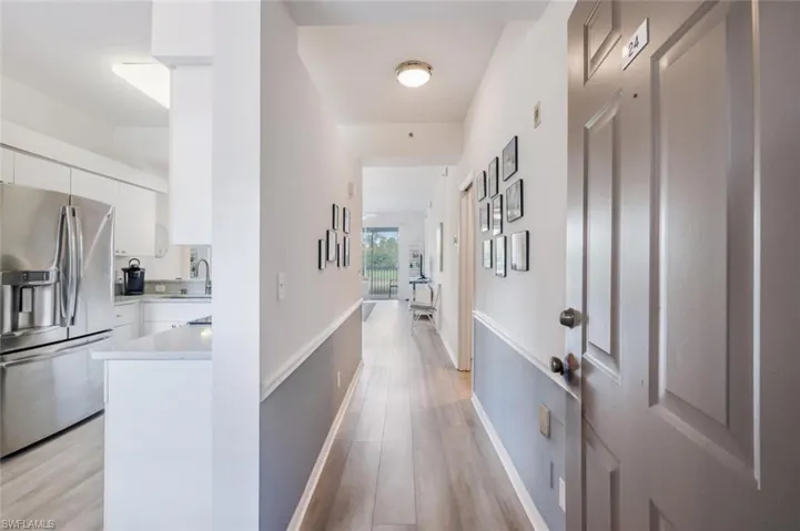 Hallway featuring light wood finished floors and baseboards