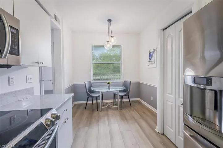 Dining area featuring light wood-style floors and baseboards