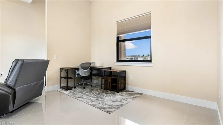Office area with baseboards and marble finish floor