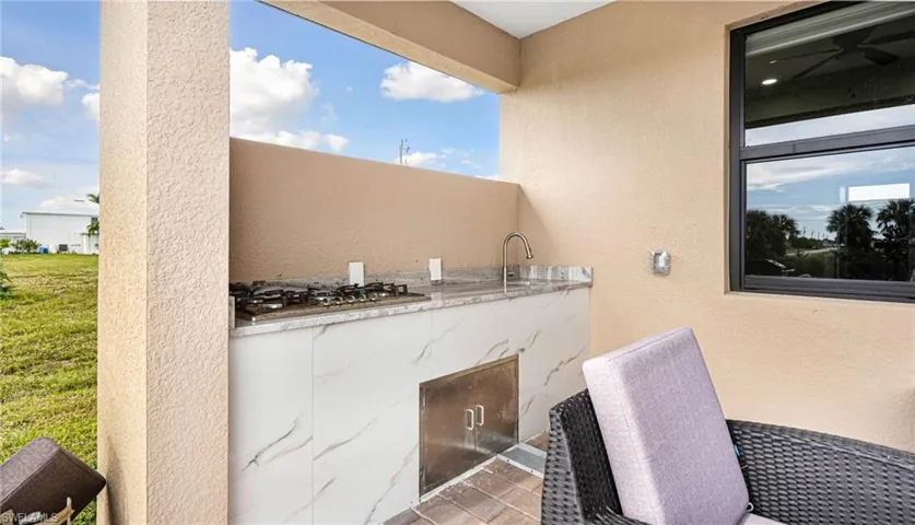 View of patio / terrace featuring exterior kitchen and a sink
