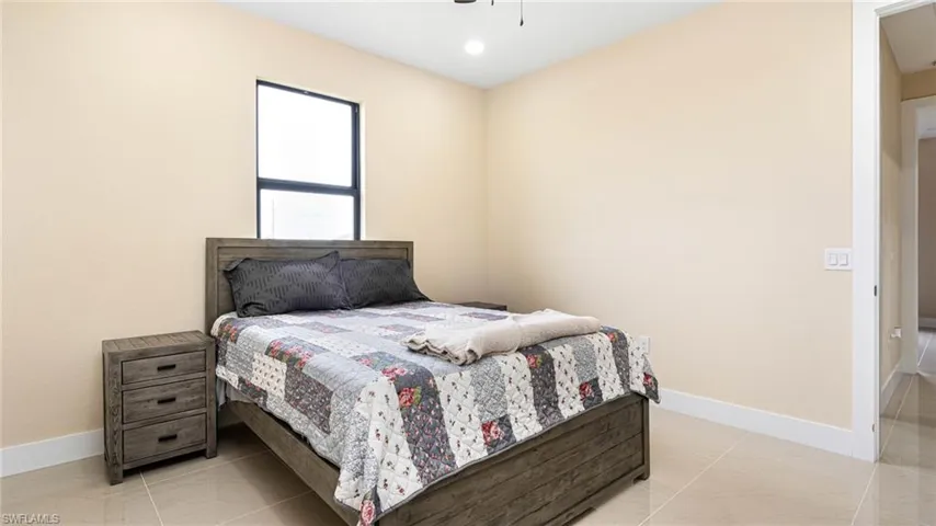 Bedroom featuring baseboards and ceiling fan