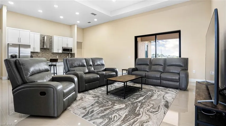 Living area featuring recessed lighting, visible vents, and baseboards