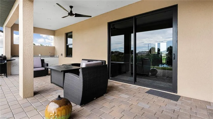 View of patio with an outdoor living space and ceiling fan