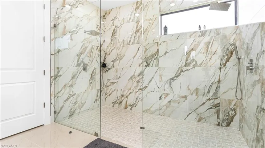 Bathroom featuring a marble finish shower