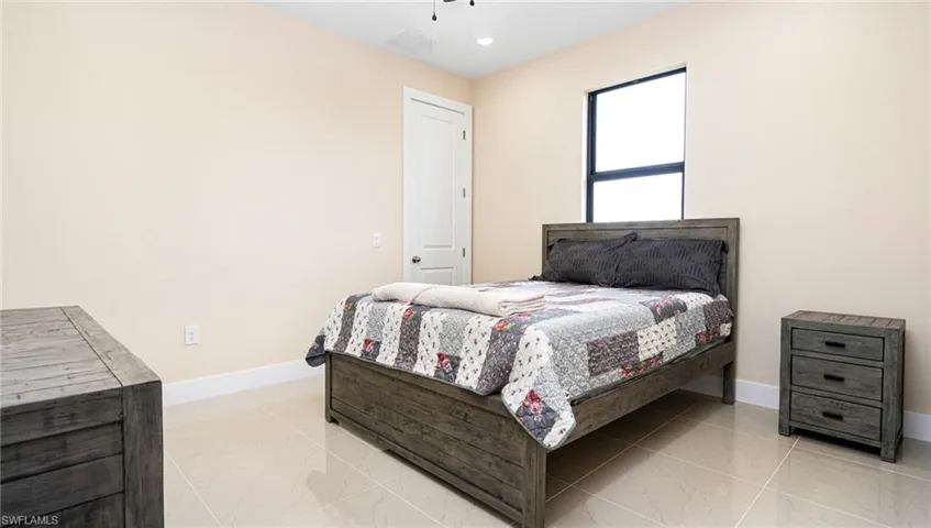 Bedroom featuring visible vents, baseboards, marble finish floor, and ceiling fan