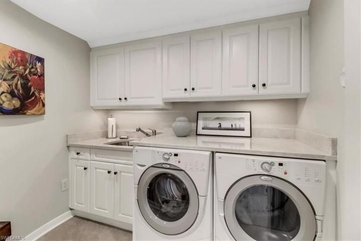 Laundry Room with Granite Countertops and Built-in Cabinets