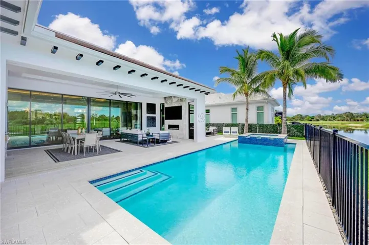 View of swimming pool with a patio, ceiling fan, an in ground hot tub, and outdoor lounge area