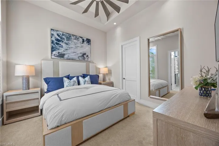 Carpeted bedroom with ceiling fan