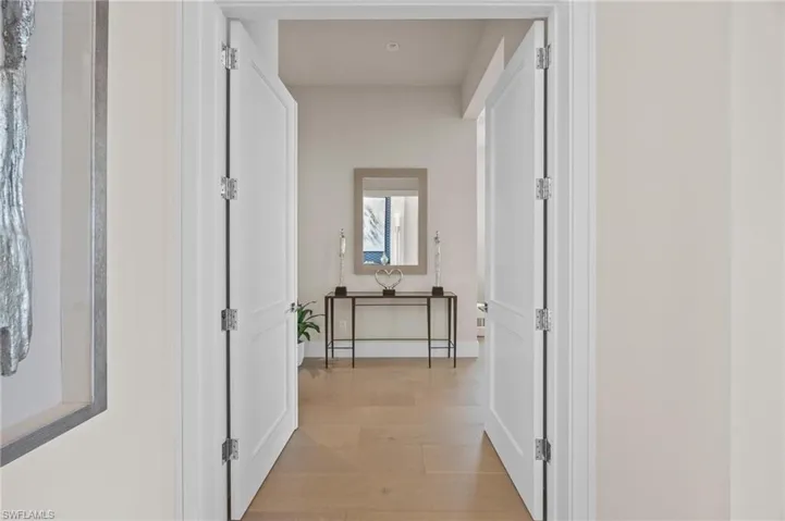 Corridor with light hardwood / wood-style flooring