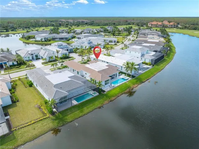 Birds eye view of property with a water view