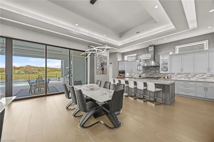 Dining space featuring light hardwood / wood-style flooring and a tray ceiling