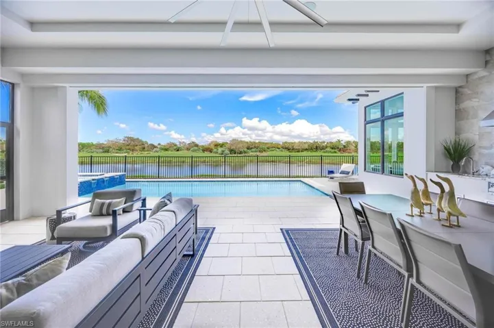 View of pool with outdoor lounge area, a patio, and ceiling fan