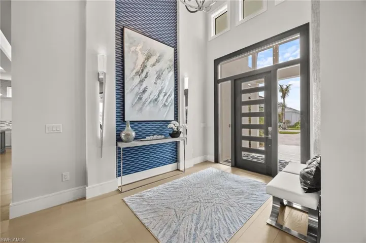Entryway featuring a high ceiling and light hardwood / wood-style flooring