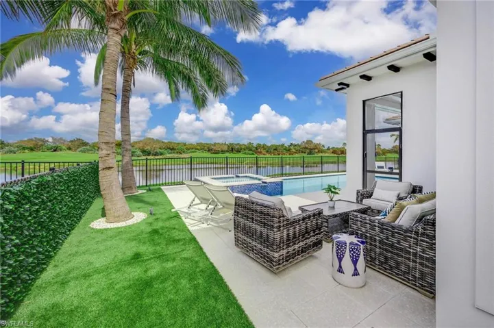 View of patio with a water view, a fenced in pool, and an outdoor hangout area